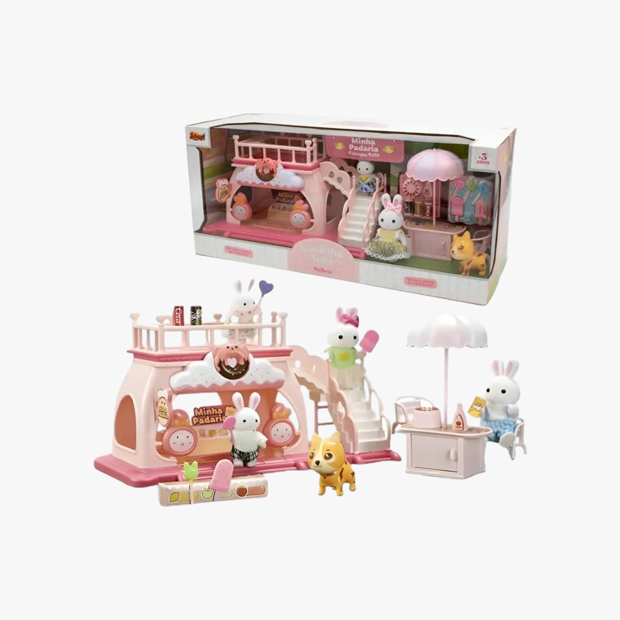 Casinha Feliz Minha Padaria com fachada rosa, dois bonecos coelho e acessórios de faz de conta dispostos na área externa